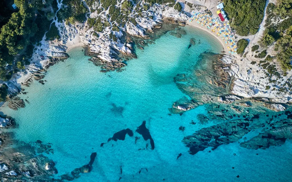 Beautiful beach and rocky coastline top aerial view drone shot, Sithonia, Greece